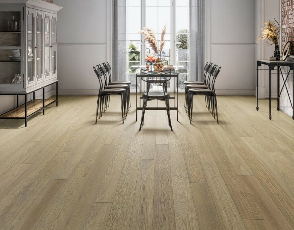 A dining room with wood floors and a table.