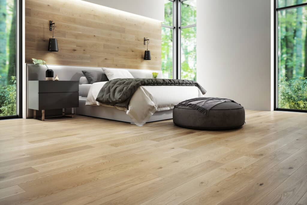 A bedroom with wood floors, showcasing the 2023 flooring trends.