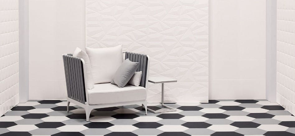 A black and white tiled room with a chair.