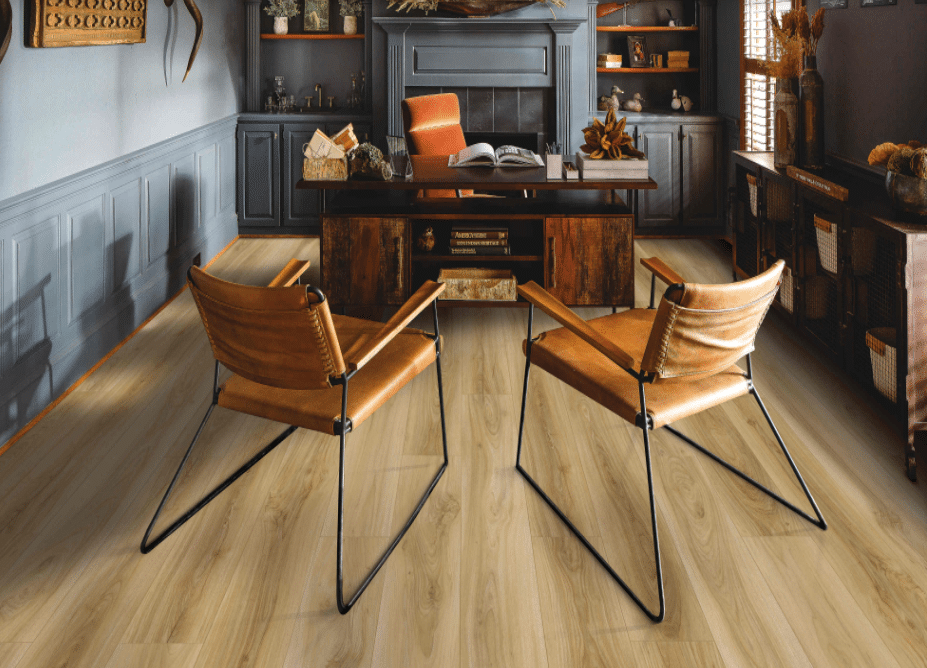 A room with Karastan luxury vinyl plank flooring and a desk.