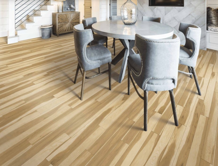 A dining room with hardwood floors and a Karastan luxury vinyl plank dining table.