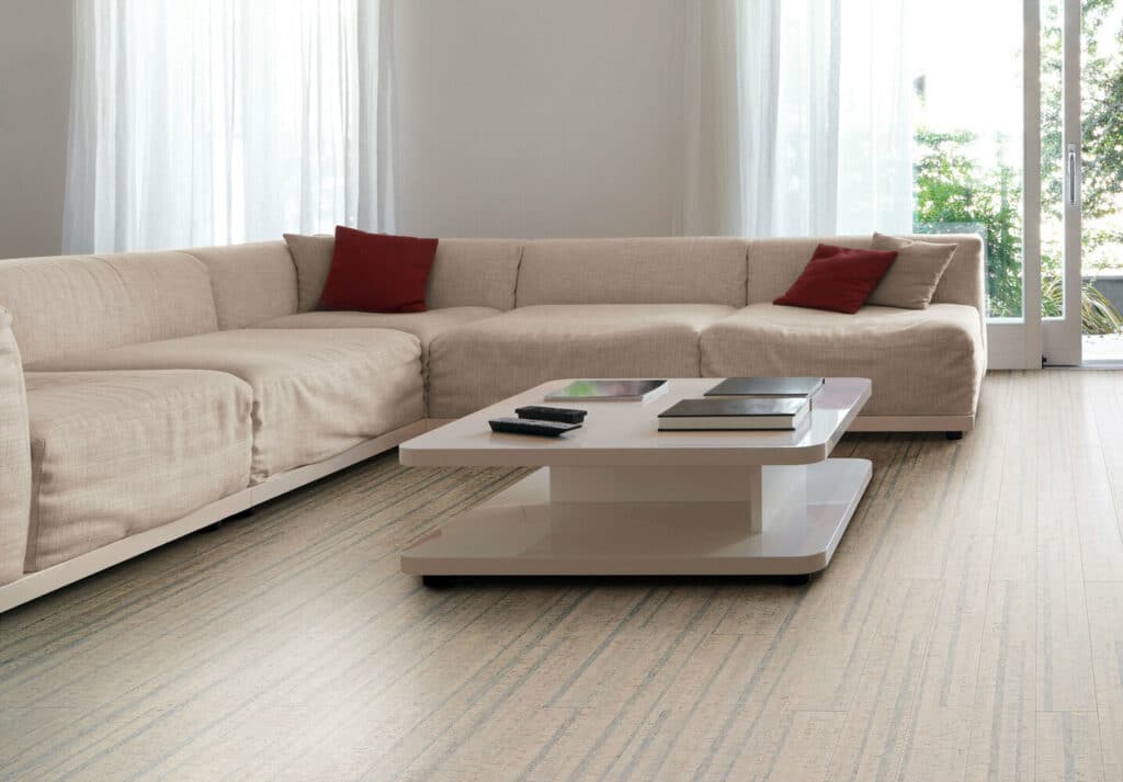 A living room with a white couch and a coffee table featuring cork flooring in West Vancouver.