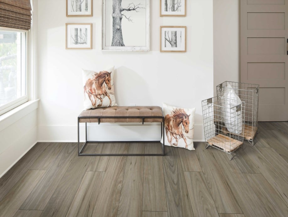 A room with wood floors and a bench, enhanced by vinyl flooring in West Vancouver.
