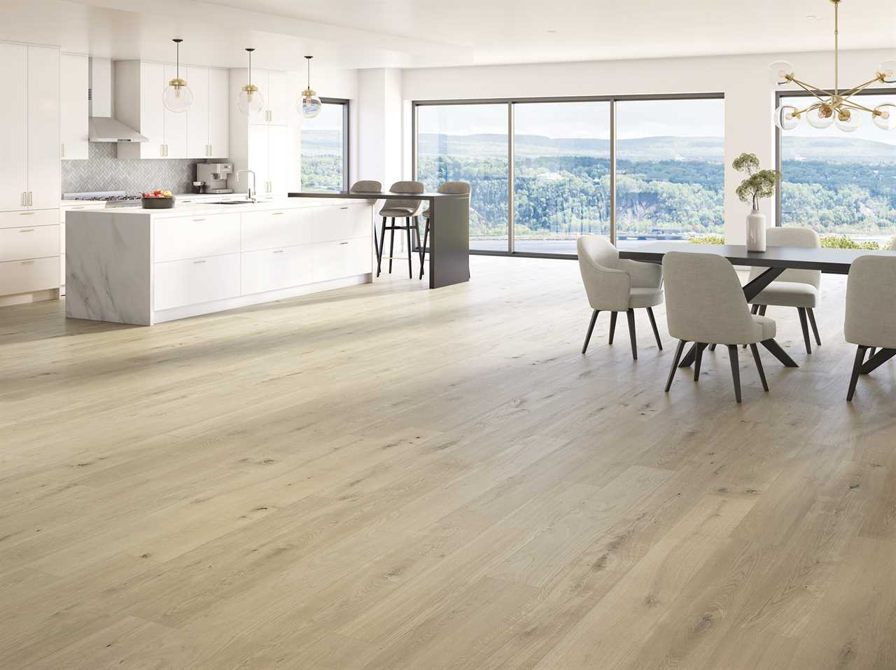 A white kitchen with wood floors and a view of the mountains.