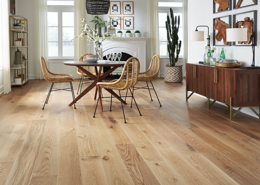 A living room with hardwood floors and a dining table.